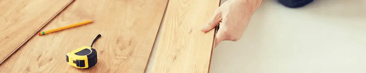A professional installing wood flooring in Oklahoma City, OK