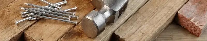 Hammer and nails on hardwood flooring boards in Oklahoma City, OK