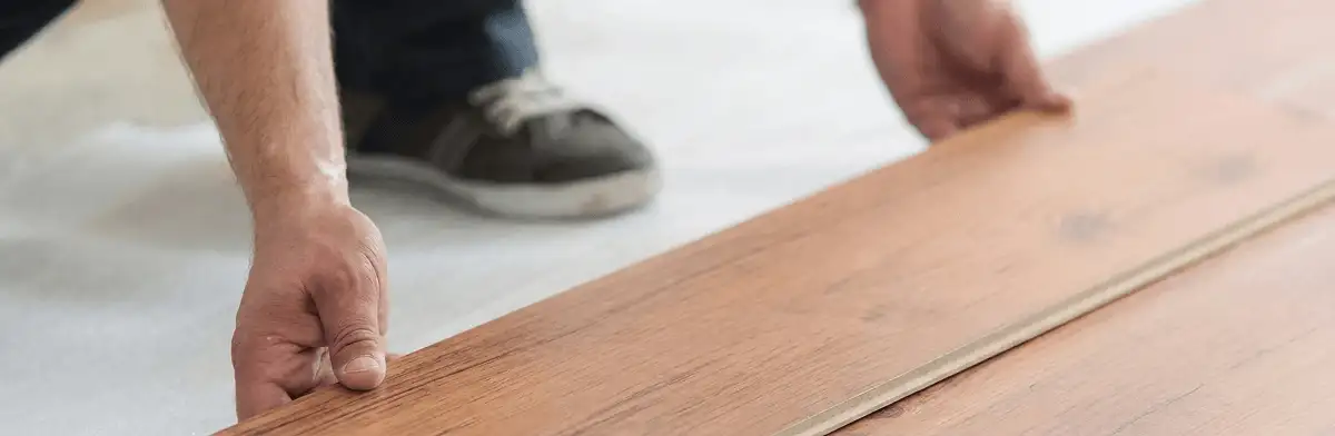 A professional installing laminate flooring in Oklahoma City, OK